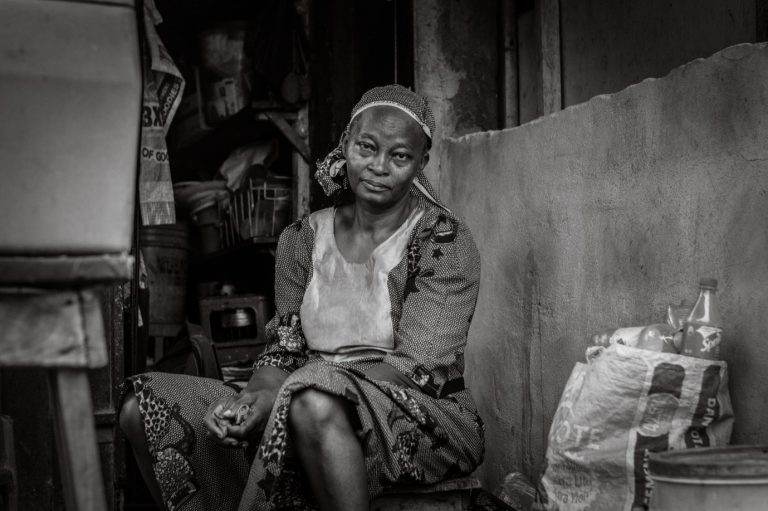 Ogunleye, sits at her shop where she sells drinks and sachet water.