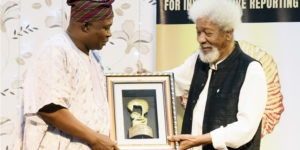 Adekunle Yusuf receiving is award from Prof Wole Soyinka